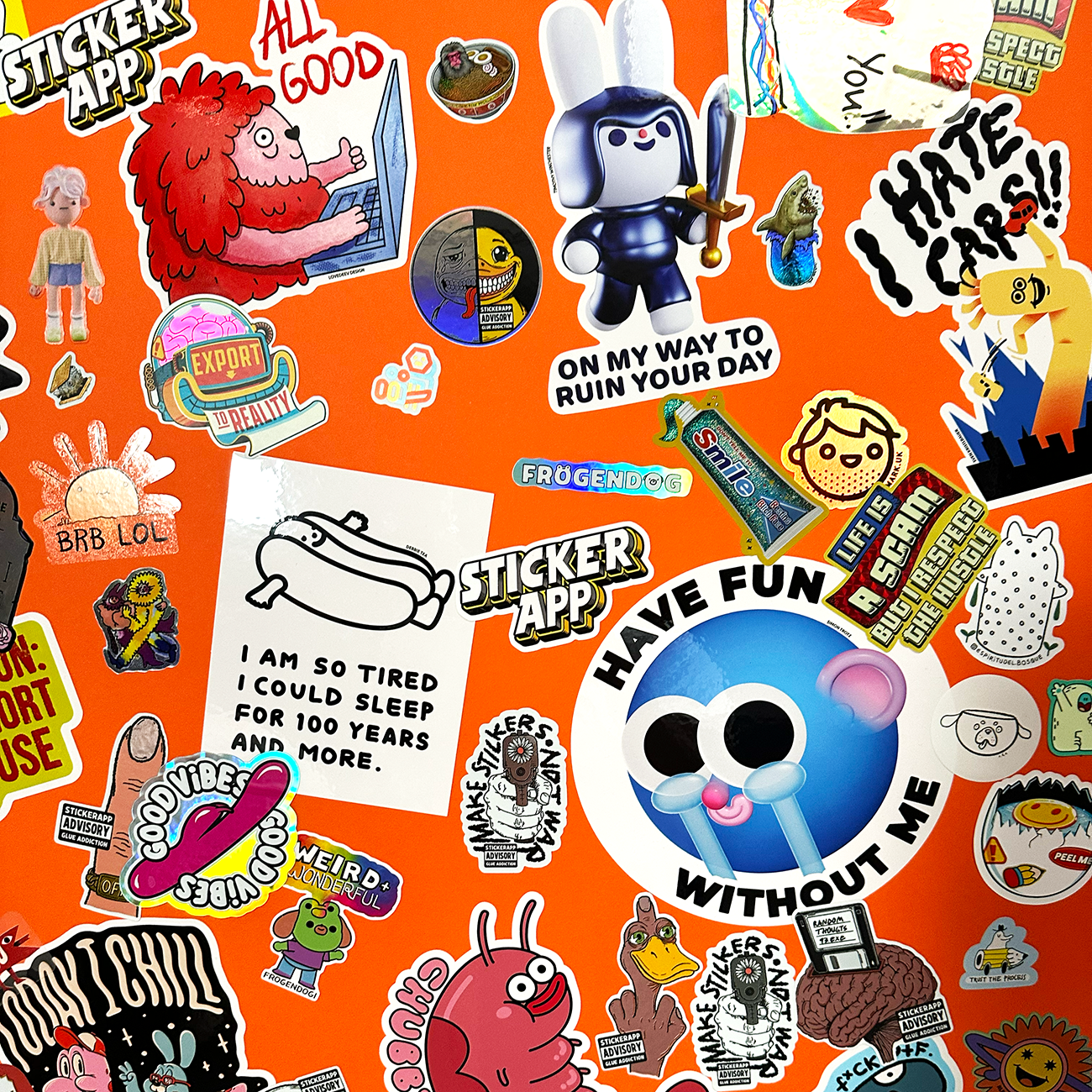 Die-cut stickers in various materials and sizes slapped on an orange wall