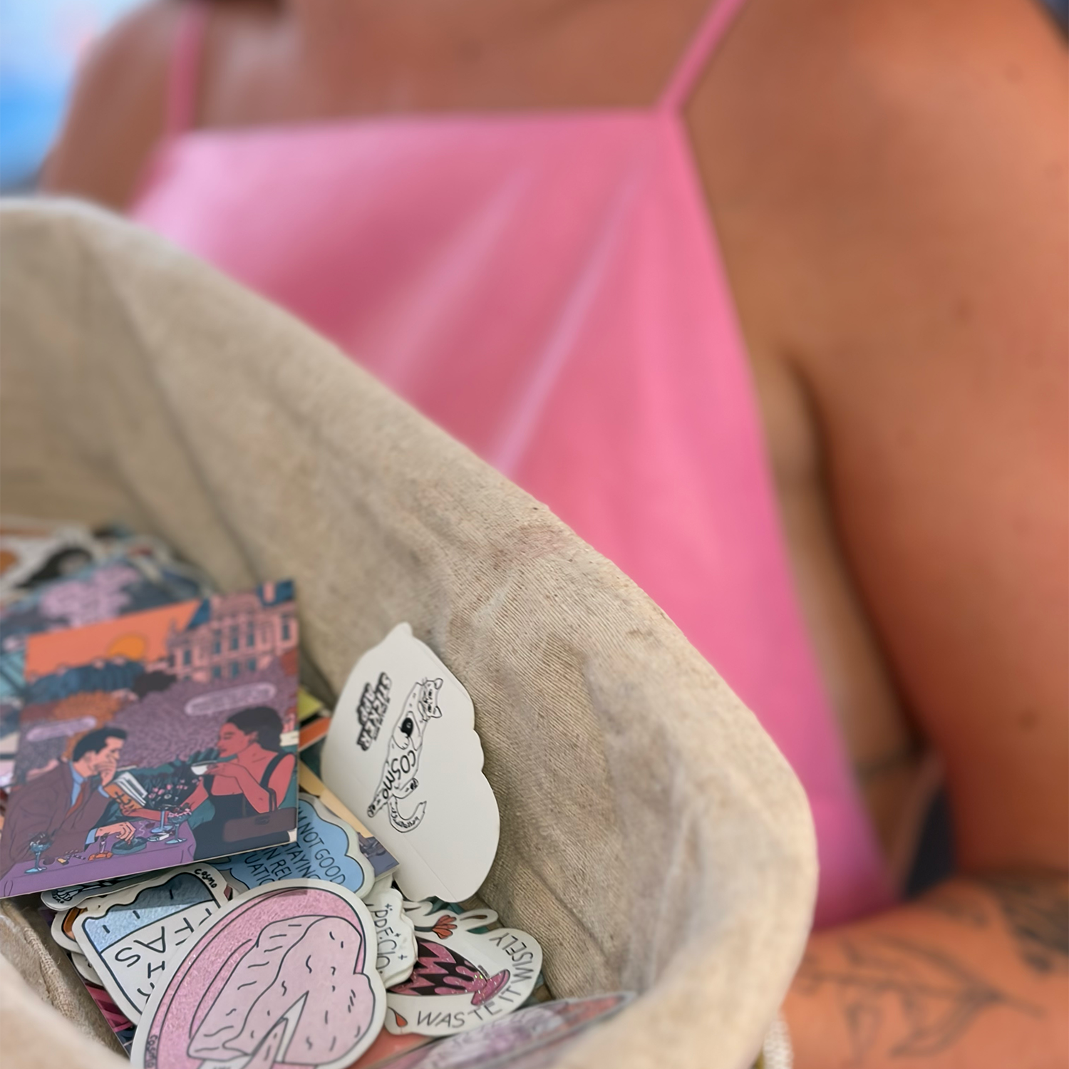 Fabric basket filled with illustrated die-cut stickers by artist Cosmo Danchin-Hamard